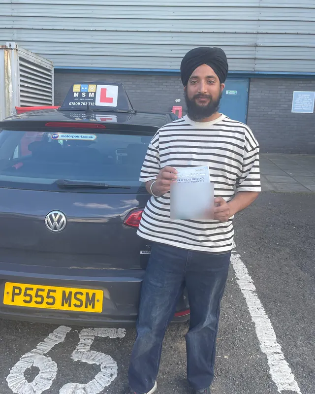 A pupil beside the MSM car after passing at Paisley